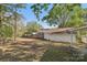 Spacious backyard with a brick home, carport, and lush greenery, offering privacy and room for outdoor activities at 1725 Feature Rd, Lancaster, SC 29720