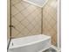 Bathroom showcasing a white tub with beige tiled walls and updated black hardware at 1725 Feature Rd, Lancaster, SC 29720