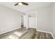 Bright bedroom features wood-look flooring, a ceiling fan, and closet space at 1725 Feature Rd, Lancaster, SC 29720
