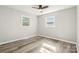Comfortable bedroom features two windows, neutral walls, and contemporary flooring at 1725 Feature Rd, Lancaster, SC 29720