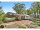 Rear exterior featuring a brick home with an open carport and a spacious, private backyard at 1725 Feature Rd, Lancaster, SC 29720