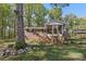 Charming brick home with a screened-in porch, mature trees, and a large front yard at 1725 Feature Rd, Lancaster, SC 29720