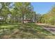 Charming single-story home with mature trees, a carport and a spacious front yard at 1725 Feature Rd, Lancaster, SC 29720