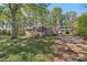 Charming brick home with a screened-in porch and mature trees, nestled in a lush front yard at 1725 Feature Rd, Lancaster, SC 29720
