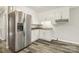 Bright kitchen featuring white cabinets, modern appliances, and attractive laminate flooring at 1725 Feature Rd, Lancaster, SC 29720
