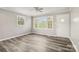 Living room featuring updated flooring, a bright window, and a front door at 1725 Feature Rd, Lancaster, SC 29720