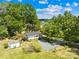 Aerial view of home with outbuilding showing mature trees and proximity to area shopping at 223 Circle Dr # 5/6, Albemarle, NC 28001