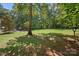 Green grassy backyard area with large trees providing shade at 162 Hoover Rd, Troutman, NC 28166