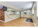 Open basement with mirrors, wood wall, vinyl floors and ceiling fan at 5300 Green Rea Rd, Charlotte, NC 28226