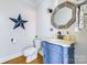 A charming powder room features a unique blue vanity and stylish mirror at 5300 Green Rea Rd, Charlotte, NC 28226