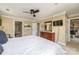Bright bedroom with a TV and a walk-in closet adjacent to the bathroom at 5300 Green Rea Rd, Charlotte, NC 28226