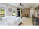 Bedroom featuring a brick fireplace, ceiling fan, and large windows offering natural light at 5300 Green Rea Rd, Charlotte, NC 28226