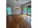 A sunlit dining room with detailed flooring, wainscoting and access to the deck at 5300 Green Rea Rd, Charlotte, NC 28226