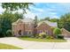 Imposing two-story brick home with a well-manicured lawn and a circular driveway leading to a side-entry garage at 5300 Green Rea Rd, Charlotte, NC 28226