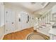 Inviting foyer with hardwood floors, a staircase with white railings, and an arched doorway with glass detailing at 5300 Green Rea Rd, Charlotte, NC 28226