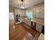 Bright kitchen featuring white cabinetry, stainless steel appliances, and a seamless flow into the adjacent dining area at 5300 Green Rea Rd, Charlotte, NC 28226