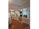 Open-concept living room with hardwood floors, a fireplace, built-in shelving, and plenty of natural light at 5300 Green Rea Rd, Charlotte, NC 28226