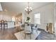 Bright dining room with a round table, four chairs, hardwood floors, and views into the open kitchen at 625 Highland Ridge Pt, Clover, SC 29710