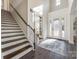 Elegant foyer featuring dark wood floors, staircase, and decorative glass doors at 625 Highland Ridge Pt, Clover, SC 29710