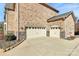 Two-car garage with stone accents and driveway at 625 Highland Ridge Pt, Clover, SC 29710