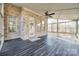 Enclosed sunroom with brick walls, large windows, dark floors, and natural light, and a ceiling fan at 625 Highland Ridge Pt, Clover, SC 29710