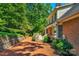 Brick patio and deck create an inviting outdoor space, nestled beside lush landscaping at 118 Cramer Mountain Woods Rd, Cramerton, NC 28032