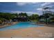 Resort-style pool with a clubhouse, lounge chairs, and a waterslide at 118 Cramer Mountain Woods Rd, Cramerton, NC 28032