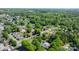 A neighborhood aerial view showcasing the lush greenery and the rooftops of the surrounding homes and the verdant landscape at 112 S 2Nd Ave, Maiden, NC 28650