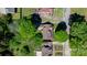 Aerial view of a charming brick home nestled among lush greenery at 112 S 2Nd Ave, Maiden, NC 28650