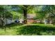 Lush backyard featuring mature trees and the back of the house at 112 S 2Nd Ave, Maiden, NC 28650