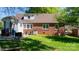 Backyard with brick and vinyl sided house and small patio at 112 S 2Nd Ave, Maiden, NC 28650
