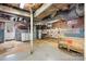 Unfinished basement with exposed ductwork and brick, offering potential for customization at 112 S 2Nd Ave, Maiden, NC 28650