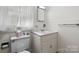 Cozy bathroom features a white vanity, tiled walls, and a bright window at 112 S 2Nd Ave, Maiden, NC 28650
