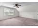 Upstairs bedroom featuring neutral carpet, windows and a ceiling fan at 112 S 2Nd Ave, Maiden, NC 28650
