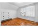 Bright bedroom with hardwood floors, paneled walls and natural light from the window at 112 S 2Nd Ave, Maiden, NC 28650