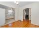 Dining room featuring hardwood floors leading to the kitchen and fireplace at 112 S 2Nd Ave, Maiden, NC 28650