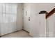 Bright foyer with an entryway door and staircase with carpeted landing at 112 S 2Nd Ave, Maiden, NC 28650