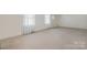 Spacious living room with carpet, large windows, and baseboard trim at 112 S 2Nd Ave, Maiden, NC 28650