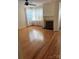 Bright living room with hardwood floors, a ceiling fan, fireplace and a large window with sheer curtains at 112 S 2Nd Ave, Maiden, NC 28650