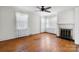 Bright living room featuring hardwood floors, a fireplace, and large windows at 112 S 2Nd Ave, Maiden, NC 28650