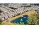 Aerial view showing homes with well-maintained yards, next to a pond with water feature in a well-planned community at 8121 Festival Way, Charlotte, NC 28215