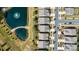 Aerial view shows backyard and pond with homes adjacent to it in a well-planned community with mature landscaping at 8121 Festival Way, Charlotte, NC 28215