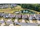 A high aerial view of homes in a beautiful community that features a pond with water feature near a wooded area at 8121 Festival Way, Charlotte, NC 28215