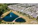 Aerial view shows backyard and pond in a well-planned community with mature landscaping and scenic views at 8121 Festival Way, Charlotte, NC 28215
