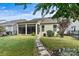 Charming backyard featuring a screened porch, well-maintained lawn and a stone pathway leading to beautiful landscaping at 8121 Festival Way, Charlotte, NC 28215
