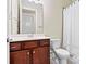 Bathroom with wooden vanity, white countertops, a mirror, and a shower with a white shower curtain at 8121 Festival Way, Charlotte, NC 28215