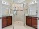 Bright bathroom featuring a large walk-in shower with glass enclosure and double vanity sinks with granite countertops at 8121 Festival Way, Charlotte, NC 28215