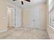 A neutrally painted bedroom features carpeted floor, a ceiling fan, and a double door closet at 8121 Festival Way, Charlotte, NC 28215