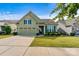 Charming home features a 2-car garage, manicured lawn, and lush landscaping at 8121 Festival Way, Charlotte, NC 28215