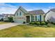 Charming single-story home with attached two-car garage and manicured front yard landscaping at 8121 Festival Way, Charlotte, NC 28215
